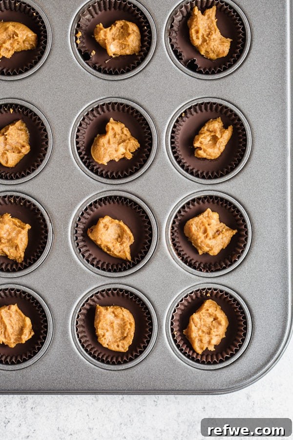 Pumpkin Chocolate Dream Cups 4 Stacked chocolate pumpkin butter cups on a rustic wooden board, ready to serve
