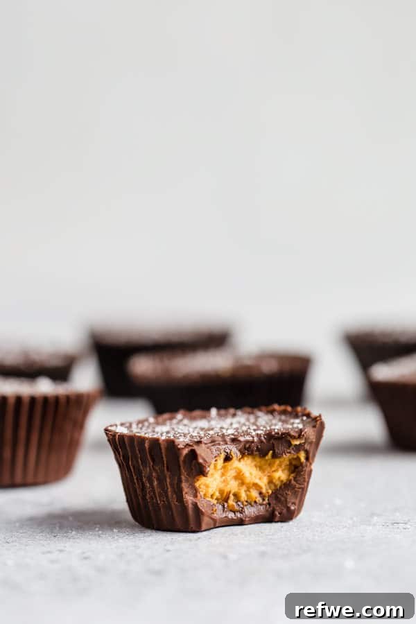 Pumpkin Chocolate Dream Cups 6 Batch of mini chocolate pumpkin butter cups cooling on a rack, freshly made