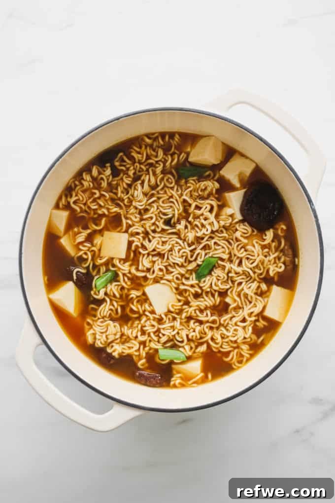 Effortless Vegan Ramen Fix 11 Vegan ramen soup in a white pot, ready to serve