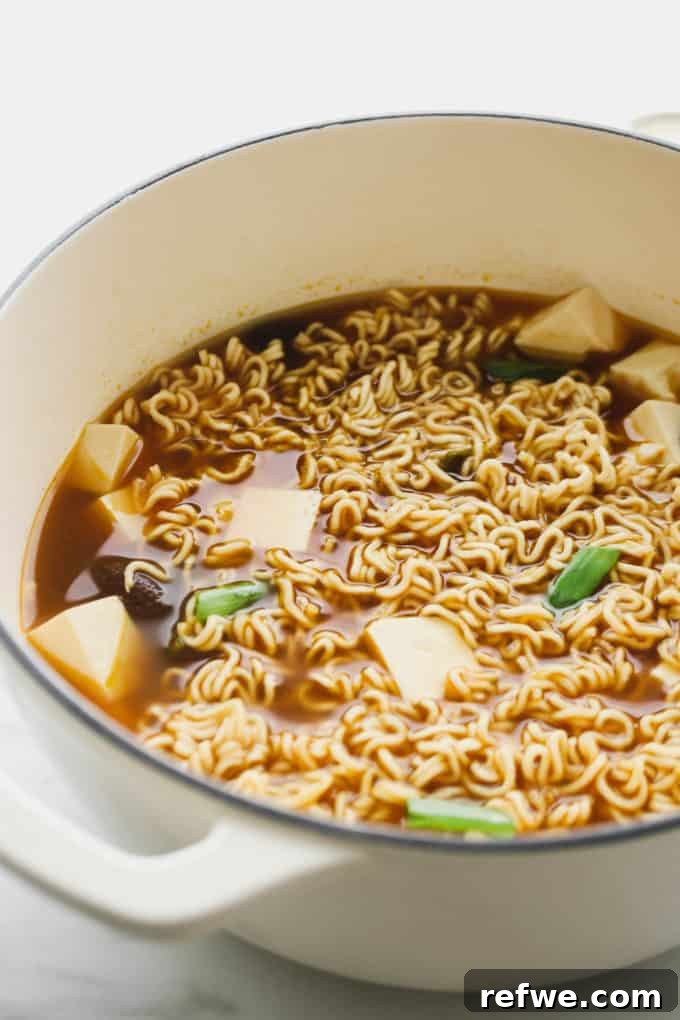 Effortless Vegan Ramen Fix 12 Close-up of vegan ramen soup with tofu in a pot