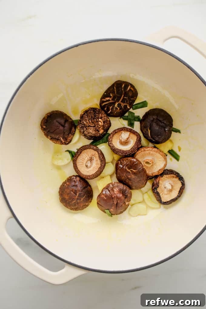 Effortless Vegan Ramen Fix 8 Dried shiitake mushrooms, garlic, ginger and green onions in a white pot