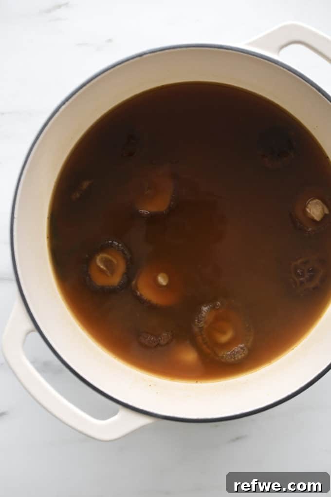 Effortless Vegan Ramen Fix 9 A white pot with vegan ramen broth simmering