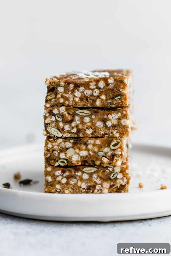 Crispy Quinoa Nut Bars 4 Four perfectly stacked puffed quinoa bars on a white plate, ready for a healthy snack.
