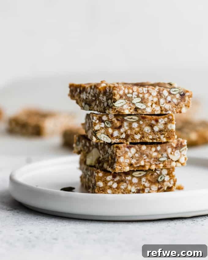Crispy Quinoa Nut Bars 7 Puffed quinoa and nut bars elegantly arranged on a white plate, ready to be served or enjoyed.