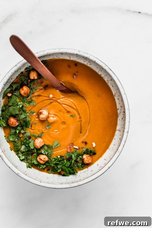 Golden Roasted Sweet Potato and Cinnamon Velouté 4 A single bowl of creamy sweet potato cinnamon soup, beautifully garnished with fresh green parsley.