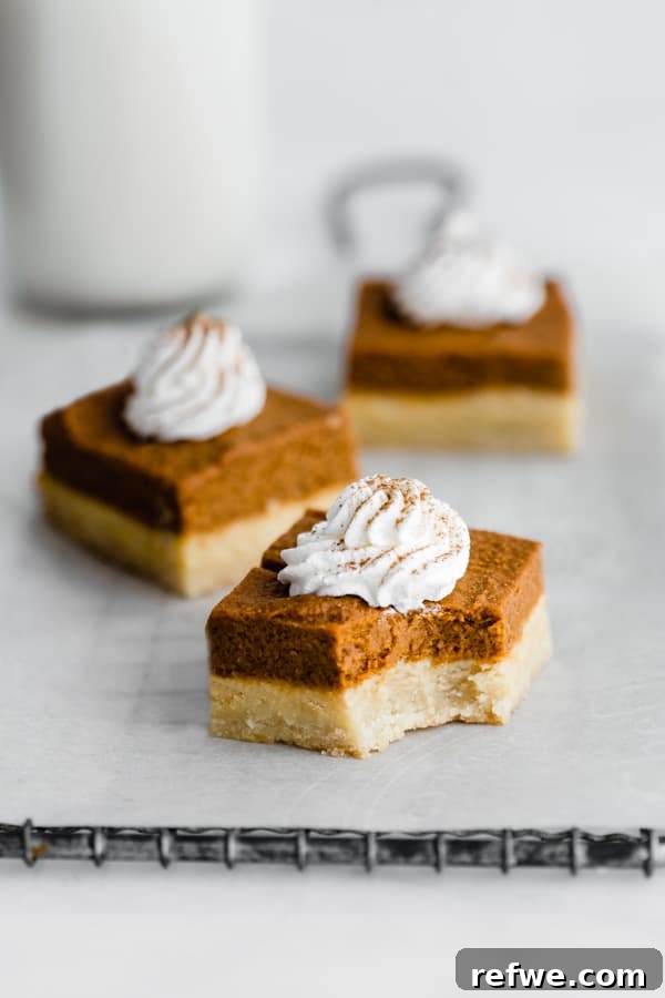 Autumn Spiced Pumpkin Bars with Almond Cookie Crust Vegan and Paleo 5 A single pumpkin pie bar topped with coconut whipped cream and a sprinkle of cinnamon.