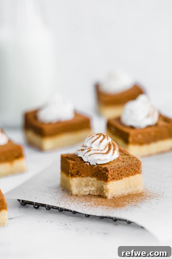 Autumn Spiced Pumpkin Bars with Almond Cookie Crust Vegan and Paleo 7 Overhead shot of freshly baked pumpkin pie bars in a square baking pan.