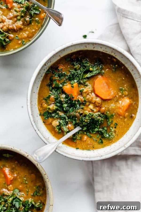 Effortless Vegan Lentil Soup: Slow Cooker Weeknight Comfort 3 A beautifully presented bowl of slow cooker lentil soup, topped with fresh chopped parsley and finely shredded carrots.