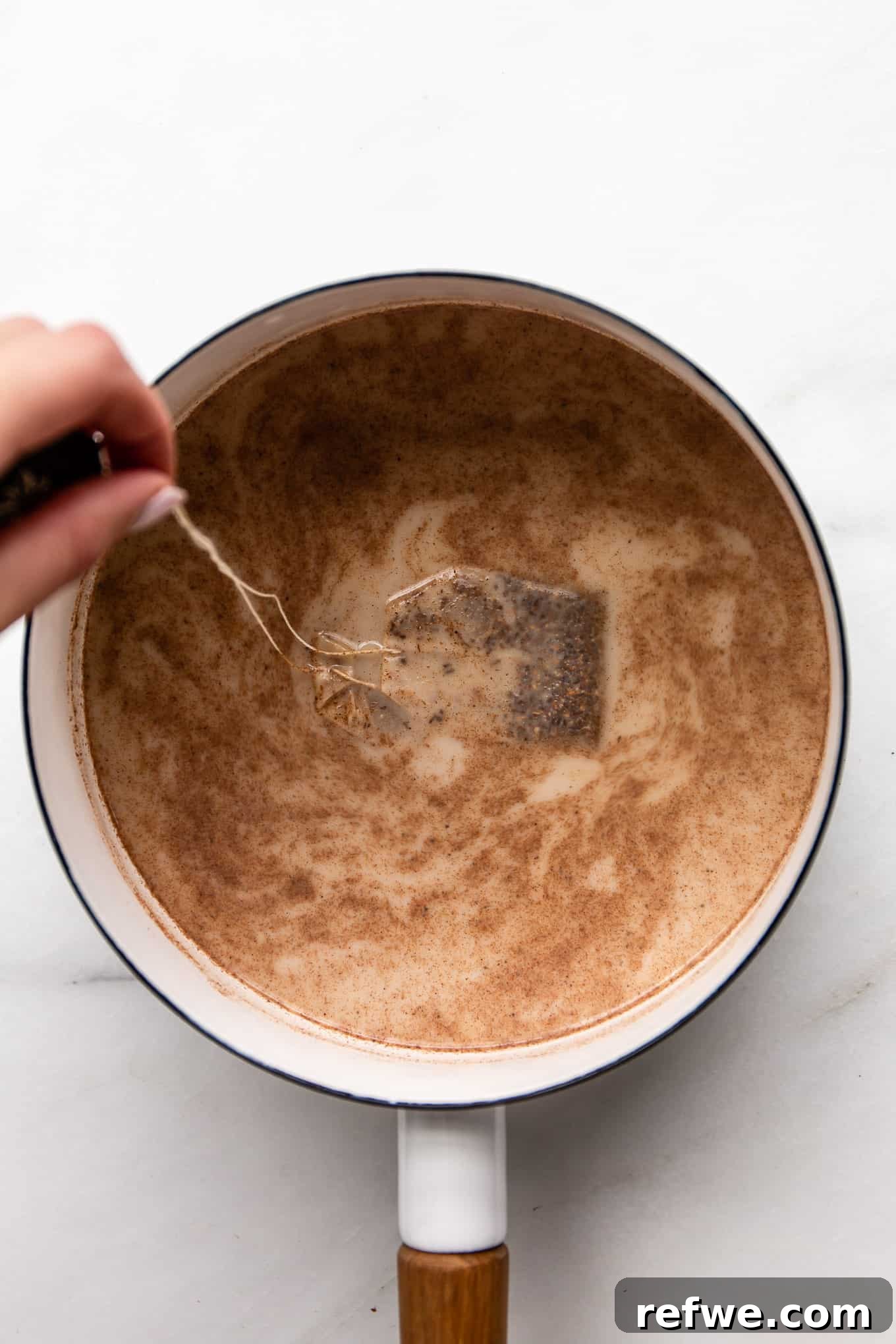 Homebrewed Chai Spice Bliss 6 Tea bags being gently dipped into the pot of spiced oat milk.