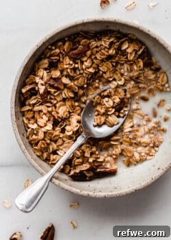 maple pecan granola in a bowl with a spoon
