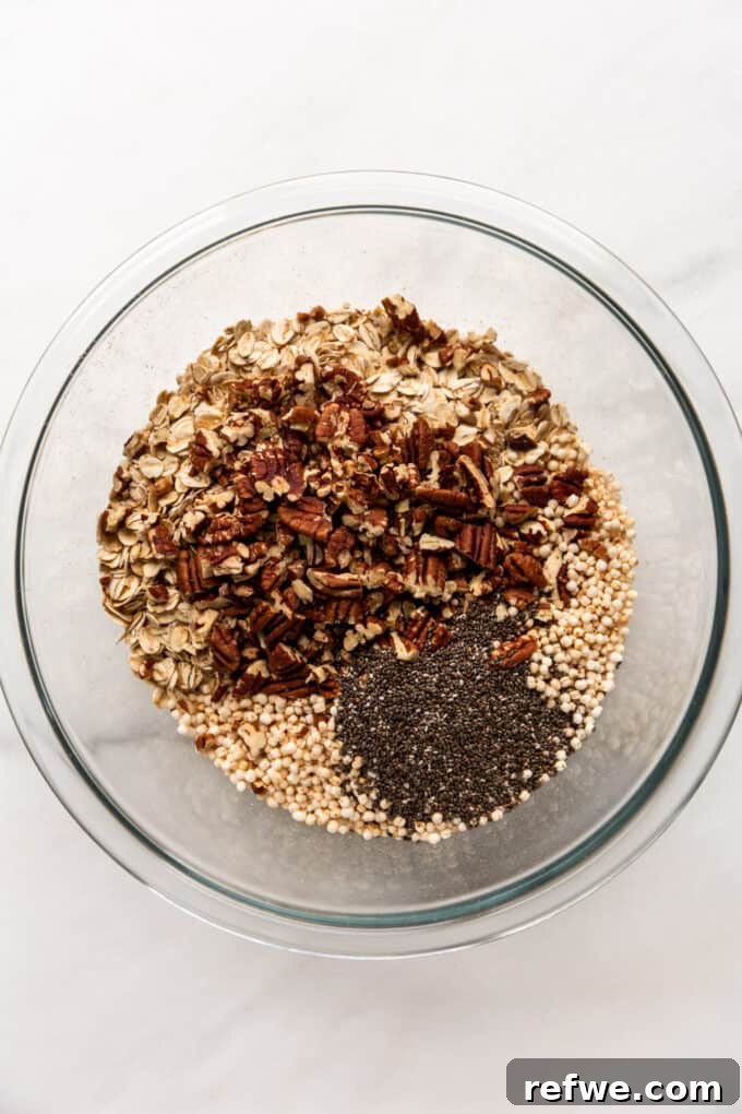 oats, pecans, puffed quinoa and chia seeds in a mixing bowl
