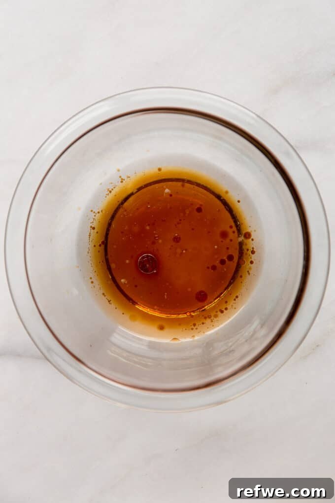 coconut oil, maple syrup and vanilla extract in a clear mixing bowl