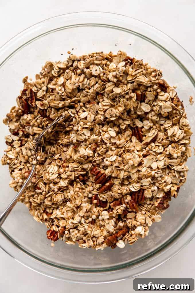 maple pecan granola mixed in a clear mixing bowl
