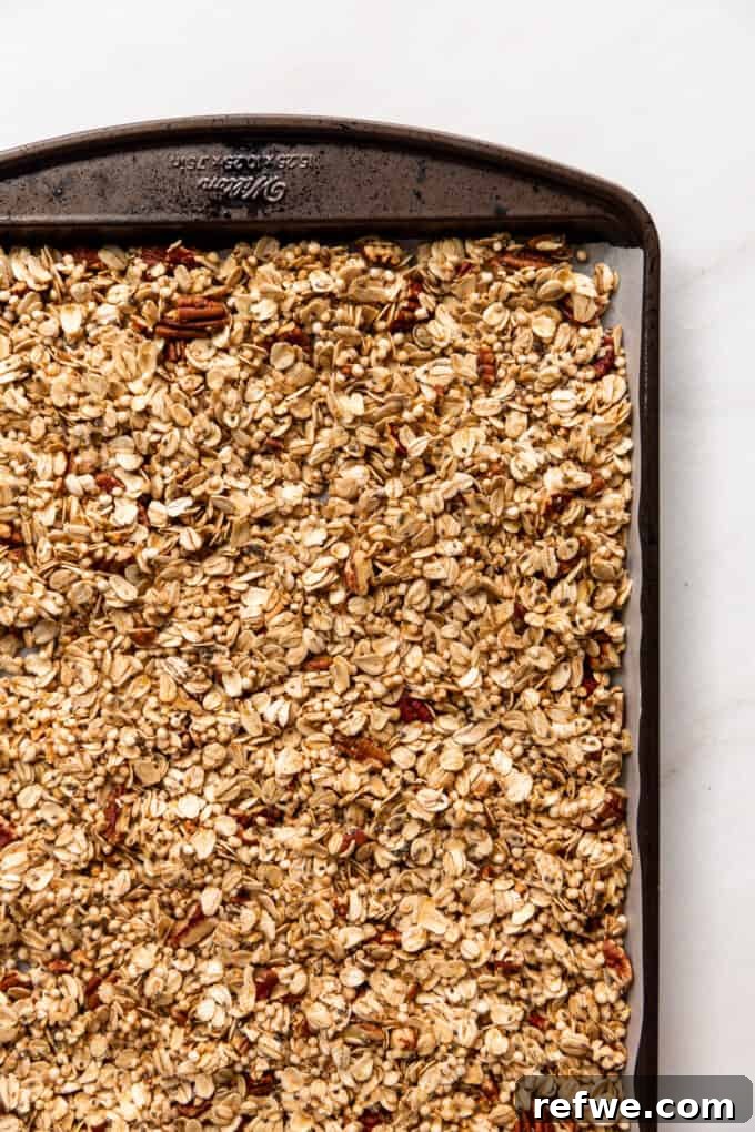 unbaked maple pecan granola on a baking sheet