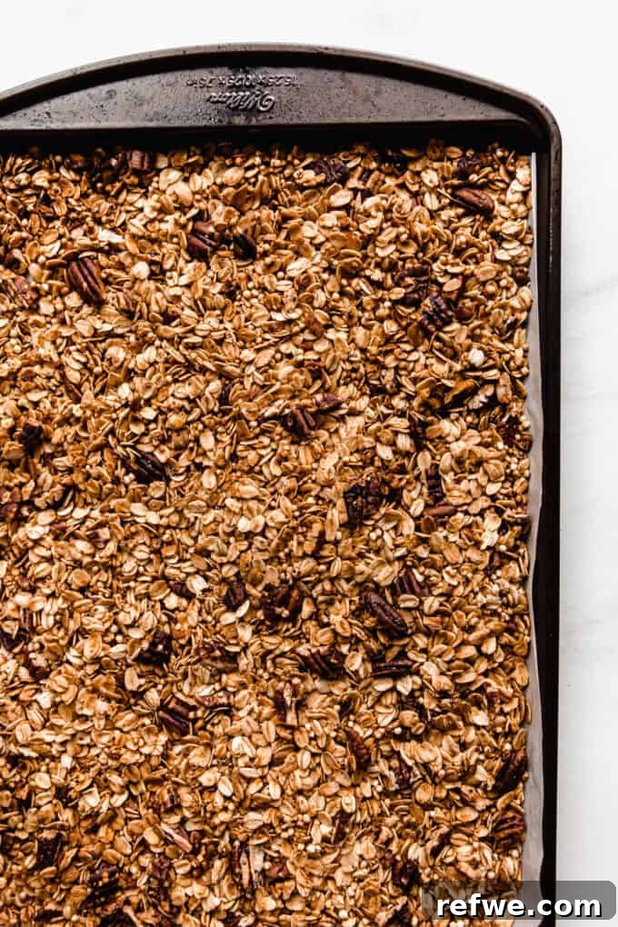 maple pecan granola toasted on a baking sheet