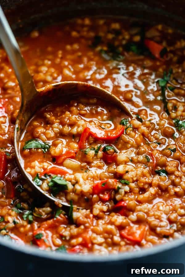 Wholesome Vegan Stuffed Pepper Stew 3 Close-up of hearty vegan stuffed pepper soup with steam rising, inviting a warm taste.