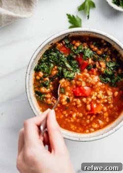 Vegan Stuffed Pepper Soup, garnished with fresh parsley.