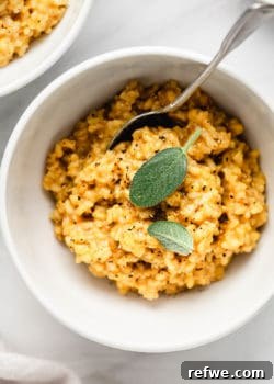 A bowl of butternut squash risotto topped with sage leaves, ready to be served.
