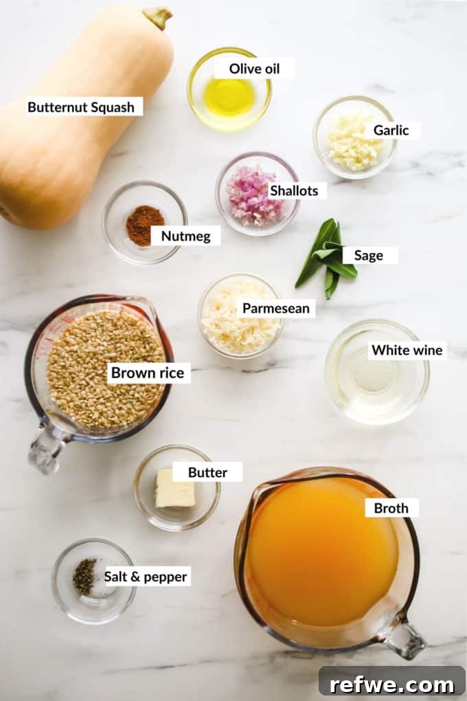 A flat lay photograph showcasing all the fresh ingredients needed for butternut squash risotto, including a whole squash, olive oil, rice, shallots, garlic, and fresh sage.