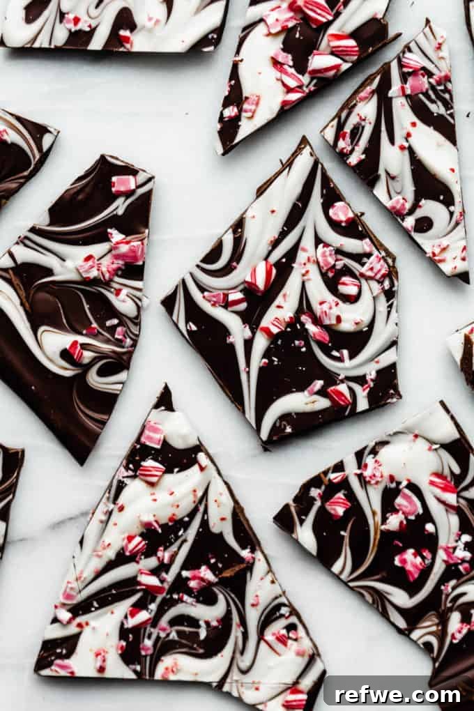 Wintermint Swirl Bark 12 Beautifully arranged pieces of Marbled Peppermint Bark on a marble tray, perfect for a holiday gathering or gifting.