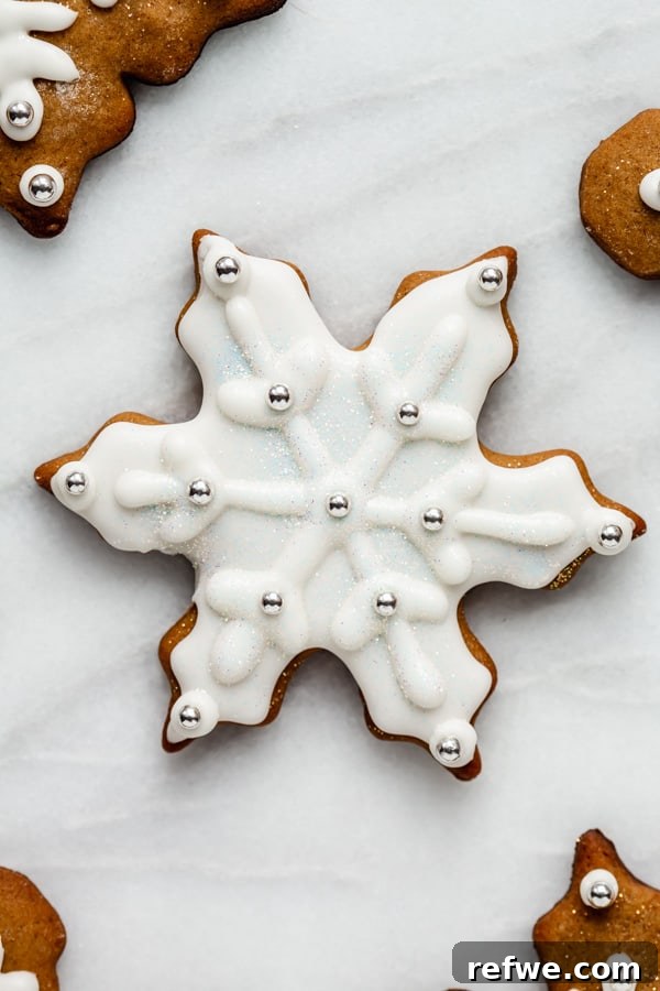 Effortless Wholesome Gingerbread Cookies 4 a snowflake gingerbread cookie covered in royal icing