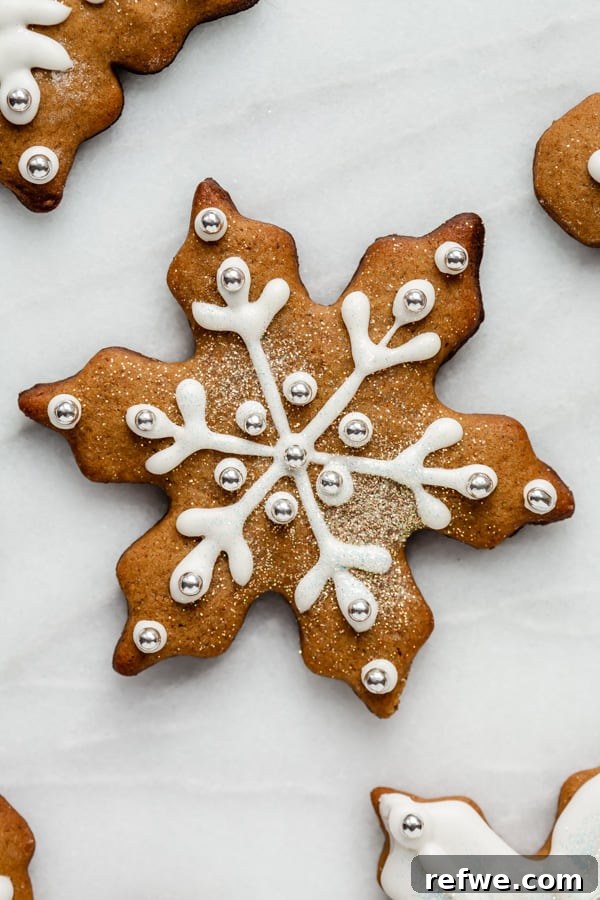 Effortless Wholesome Gingerbread Cookies 5 a snowflake gingerbread cookie topped with icing and glitter