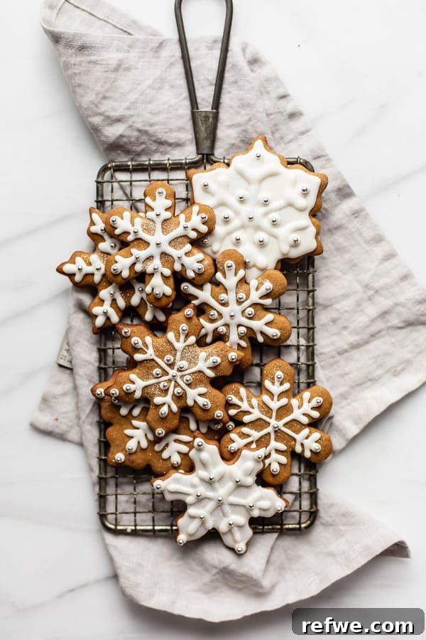 Effortless Wholesome Gingerbread Cookies 6 snowflake gingerbread cookies on a cooling rack and napkin