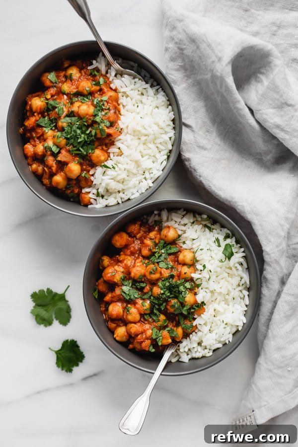 Chef's Special Chana Masala 4 A bowl of delicious restaurant-style chana masala served with rice and fresh cilantro.