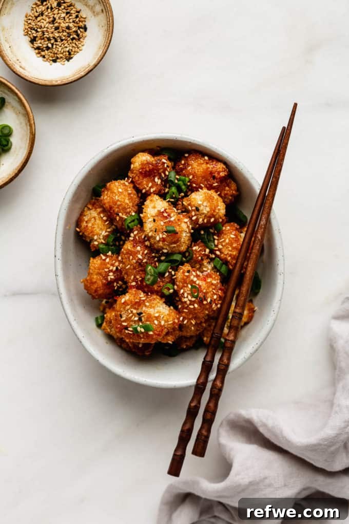 Dynamite Cauliflower 8 A beautifully presented bowl of bang bang cauliflower with chopsticks and a napkin, ready to be enjoyed