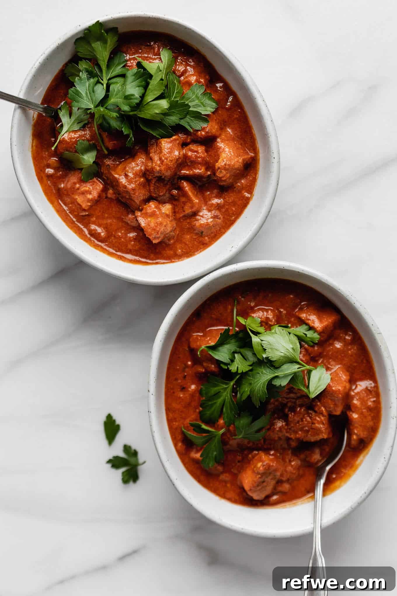 Spiced Tofu Tikka Masala Feast 2 Creamy Tofu Tikka Masala served in a bowl, garnished with fresh cilantro.