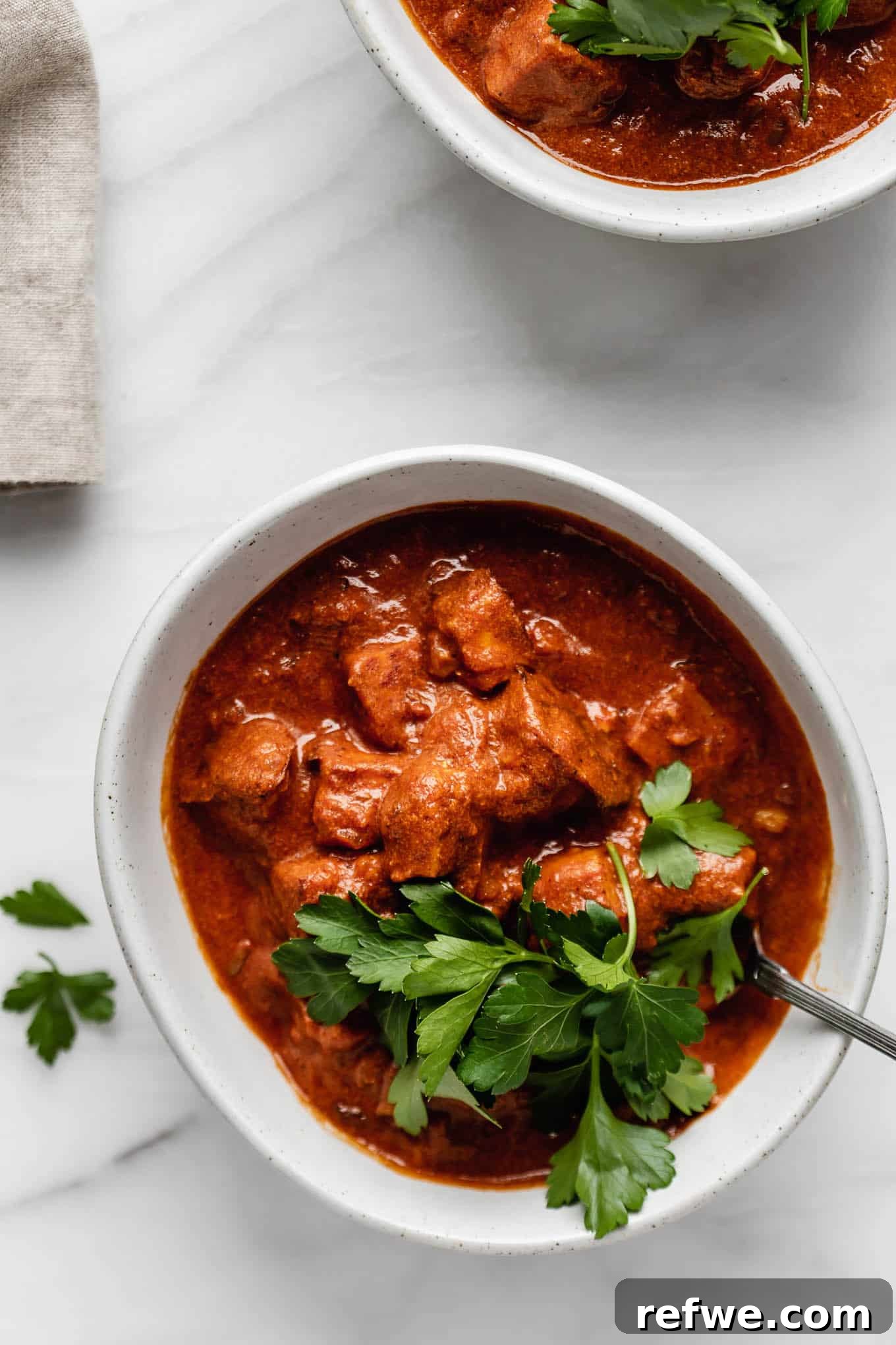 Spiced Tofu Tikka Masala Feast 4 A bowl of Tofu Tikka Masala garnished with fresh herbs, ready to be served.