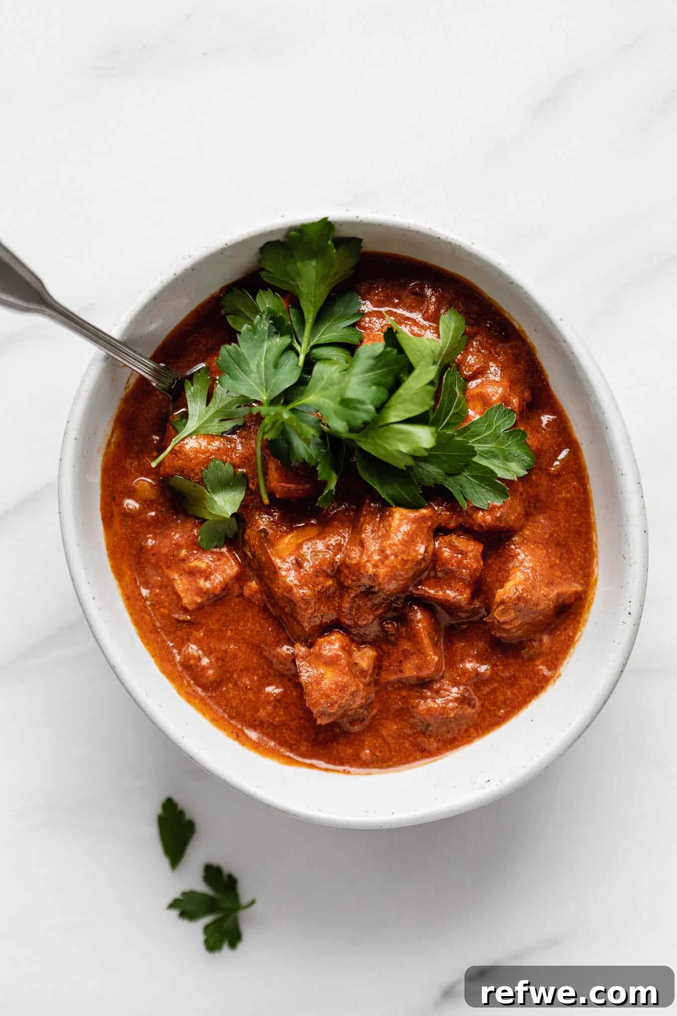 Spiced Tofu Tikka Masala Feast 5 Tofu Tikka Masala served alongside fresh naan bread and a sprinkling of cilantro.