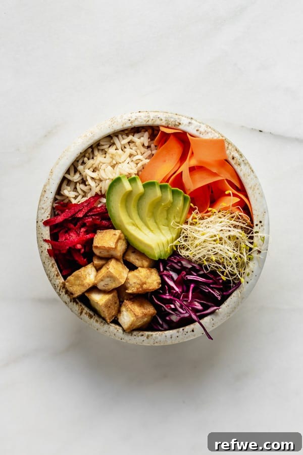 Legendary Dragon Bowls 9 A fully loaded Dragon Bowl featuring brown rice, a generous portion of crispy tofu, and a medley of colorful, fresh vegetables, inviting a delicious meal.
