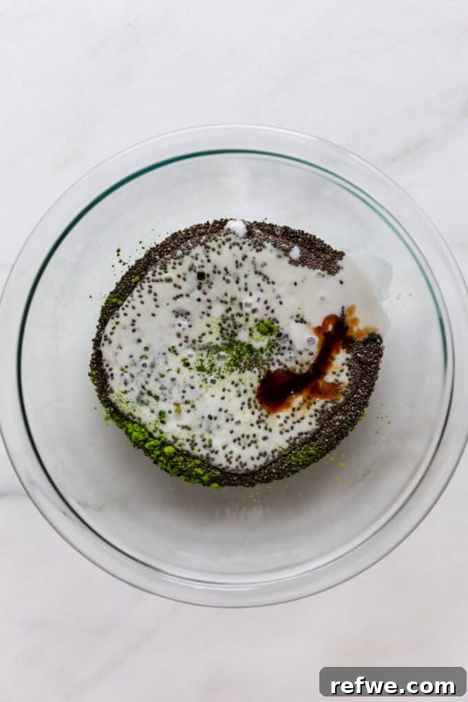 Vibrant Matcha Chia Pudding 4 A mixing bowl containing chia seeds, bright green matcha powder, creamy coconut milk, golden maple syrup, and a dash of vanilla extract, ready to be combined.