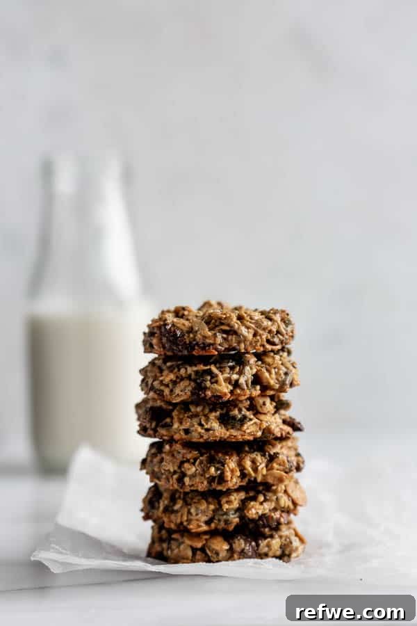 Wholesome Morning Cookie Delights 10 A charming stack of six healthy breakfast cookies resting on a piece of parchment paper, highlighting their wholesome texture and appetizing appearance.