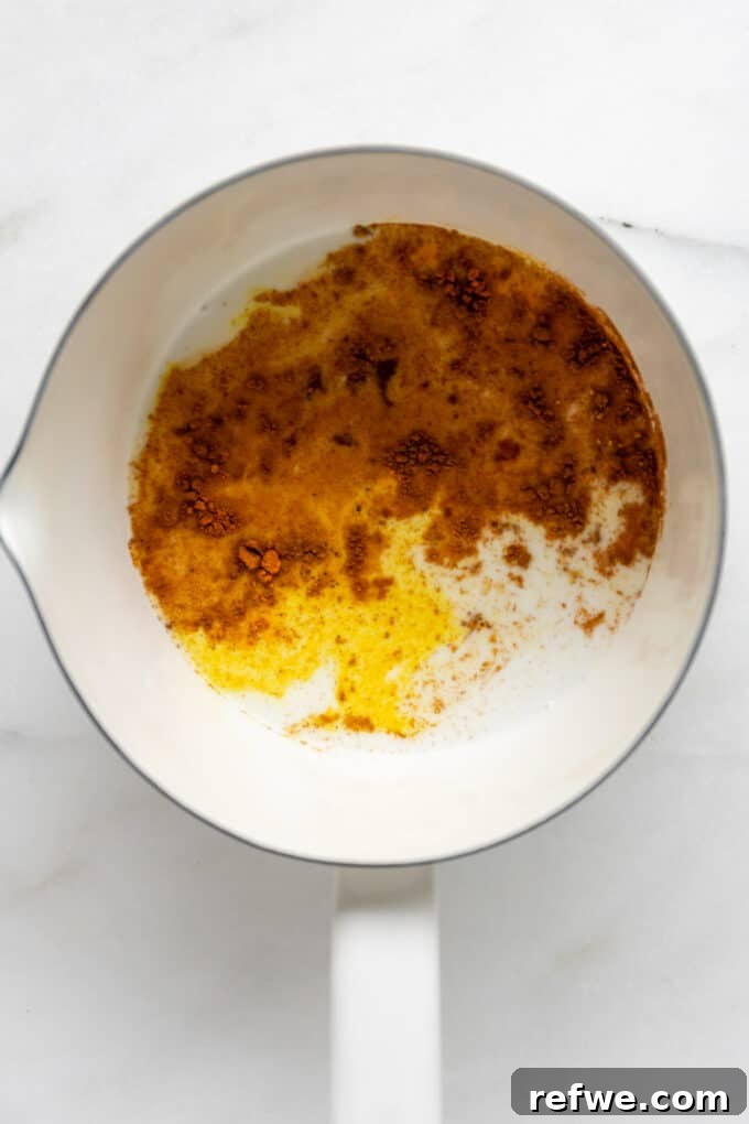 Golden Turmeric Elixir 4 spices and almond milk in a white pot