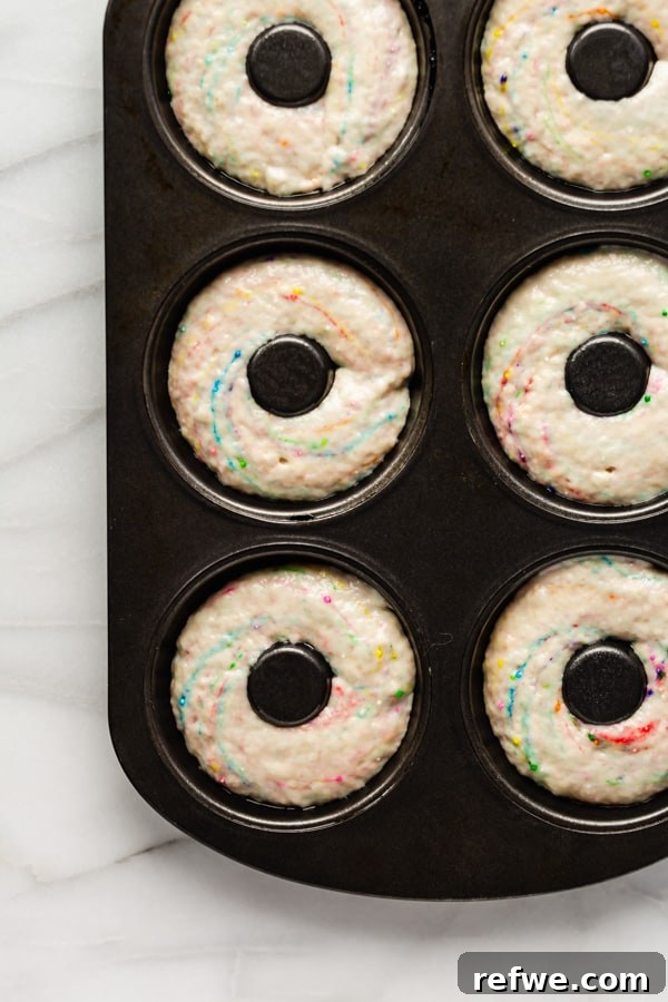 Vegan Cake Batter Bliss Donuts 3 Close-up of baked vegan cake batter donuts cooling on a wire rack