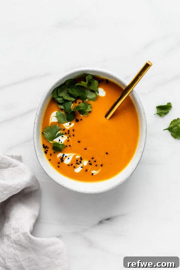 Closeup of Thai carrot ginger soup with garnishes