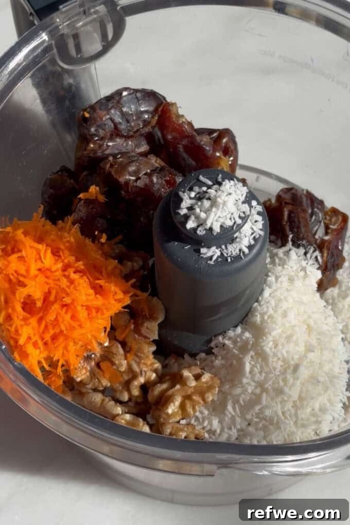 All carrot cake energy ball ingredients in a food processor, ready to be blended.
