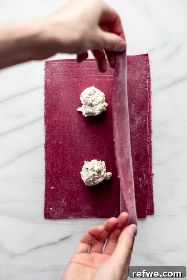 Ruby Heart Ravioli 4 Rolling out vibrant beet pasta sheets with a pasta machine to ideal thinness