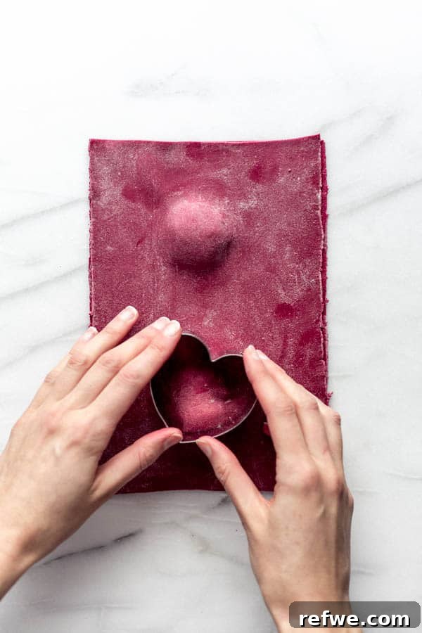 Ruby Heart Ravioli 6 Sealing heart-shaped beet ravioli before cutting, ensuring no air pockets