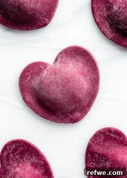Ruby Heart Ravioli 9 Heart Beet Ravioli: A vibrant, homemade pasta dish with a ricotta and mint filling.