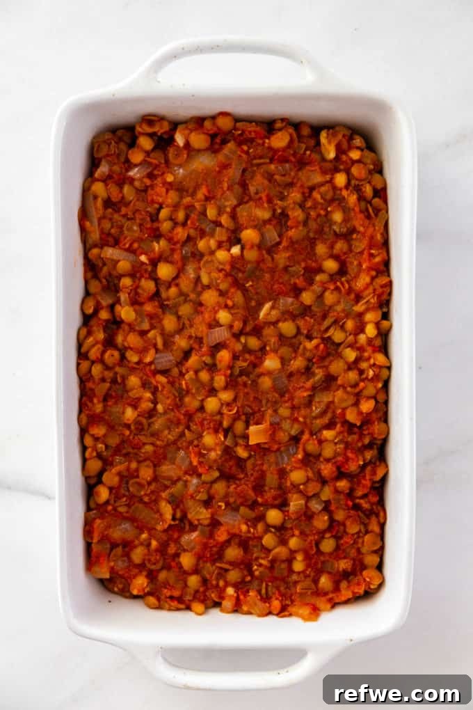 stewed lentils layered in a baking dish