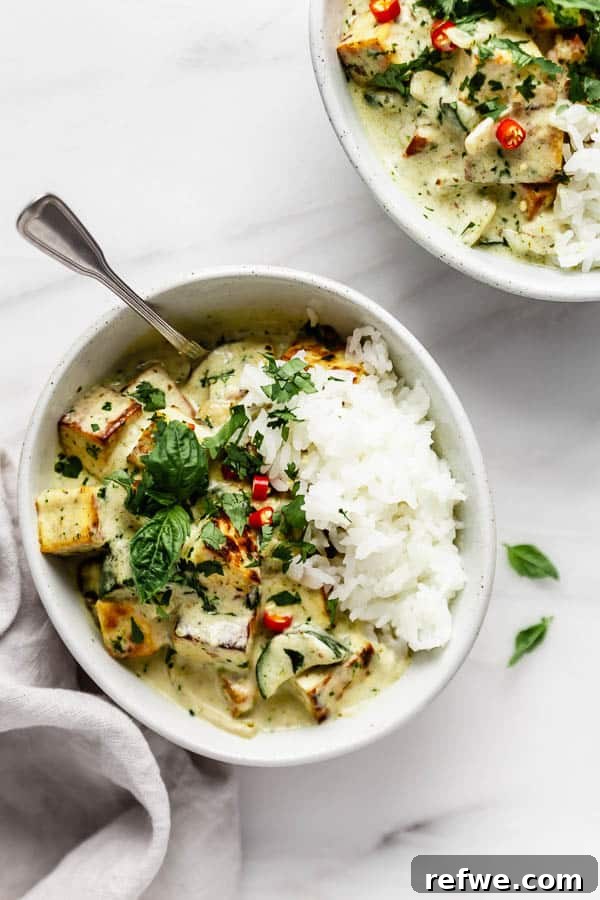 Vibrant Thai Green Tofu Curry 3 Close-up of the fragrant green curry sauce simmering with fresh herbs and spices, showcasing its vibrant color.