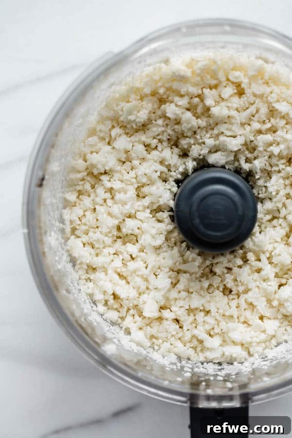 Wholesome Vegan Cauliflower Fried Rice 4 Cauliflower rice in a food processor, transforming into a rice-like texture