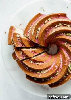 Orange Cardamom Bundt Cake with Blood Orange Glaze garnished with chopped pistachios.