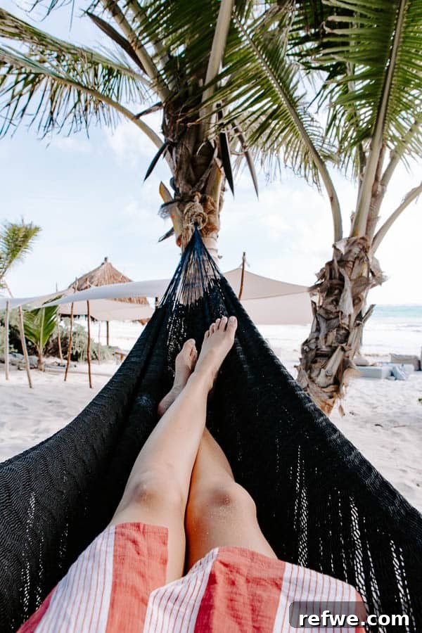 Tulum's Gastronomic Gems: A Foodie's Journey 12 A tranquil beach scene in Tulum with a hammock overlooking the ocean