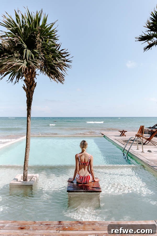Tulum's Gastronomic Gems: A Foodie's Journey 14 A person enjoying a refreshing dip in a pool surrounded by lush greenery in Tulum