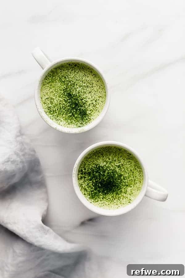 Two beautiful cups of Vanilla Macadamia Matcha Latte, garnished and ready to be enjoyed.