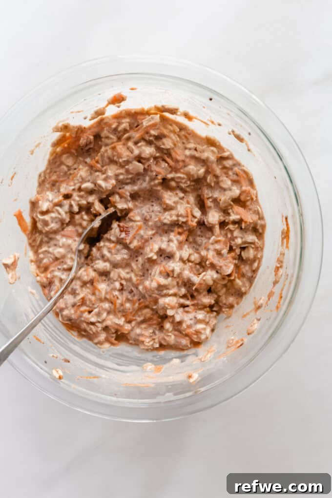 A bowl of carrot cake overnight oats mixture covered and ready to be refrigerated.